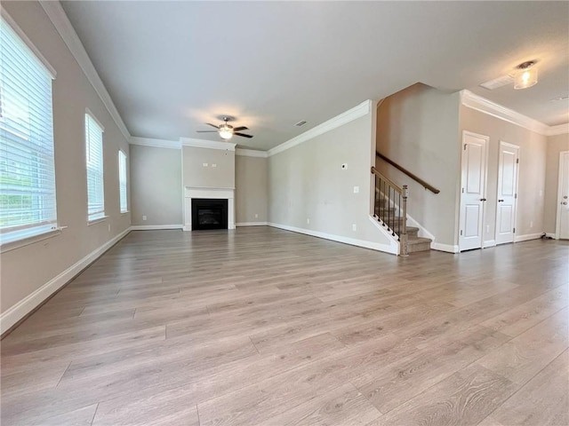 5119 Aylesbury Ct, Hoschton, GA 30548 - unfurnished living room with crown molding, a fireplace, stairway, a ceiling fan, and light wood-type flooring