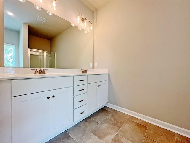 5119 Aylesbury Ct, Hoschton, GA 30548 - bathroom with a sink, a shower stall, baseboards, visible vents, and double vanity