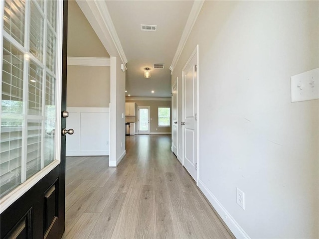 5119 Aylesbury Ct, Hoschton, GA 30548 - hallway with wainscoting, visible vents, crown molding, and light wood finished floors