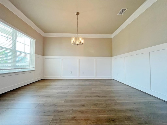 5119 Aylesbury Ct, Hoschton, GA 30548 - unfurnished dining area featuring visible vents, a notable chandelier, wood finished floors, and ornamental molding