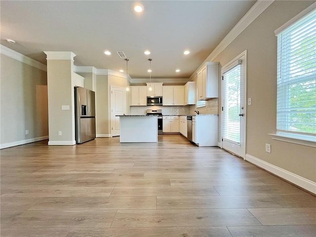 5119 Aylesbury Ct, Hoschton, GA 30548 - kitchen with light wood-style flooring, visible vents, stainless steel appliances, and open floor plan