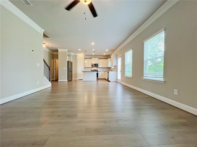 5119 Aylesbury Ct, Hoschton, GA 30548 - unfurnished living room featuring stairway, ornamental molding, baseboards, light wood-style floors, and a ceiling fan