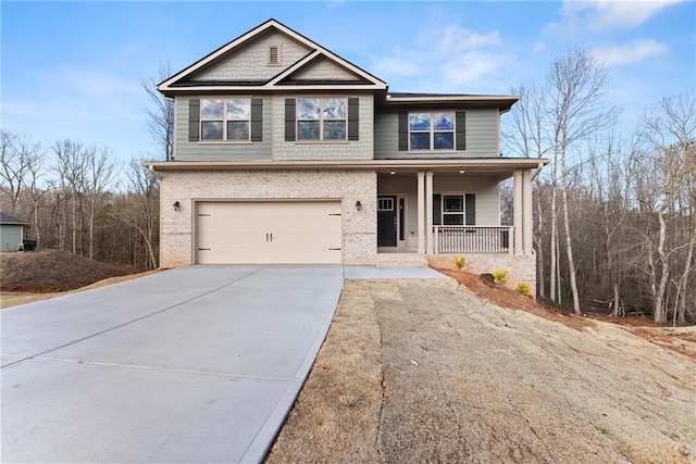 view of front facade with driveway, a porch, brick siding, and a garage
