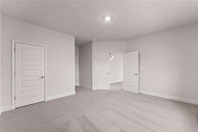 unfurnished bedroom featuring carpet flooring, baseboards, and a closet