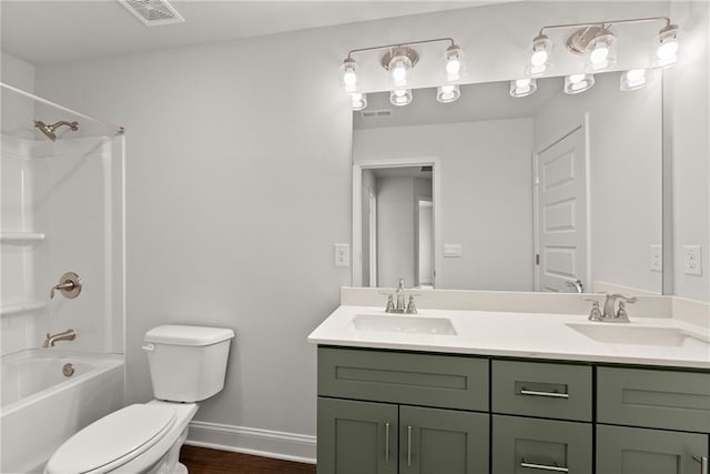 full bathroom with toilet, visible vents, double vanity, and a sink