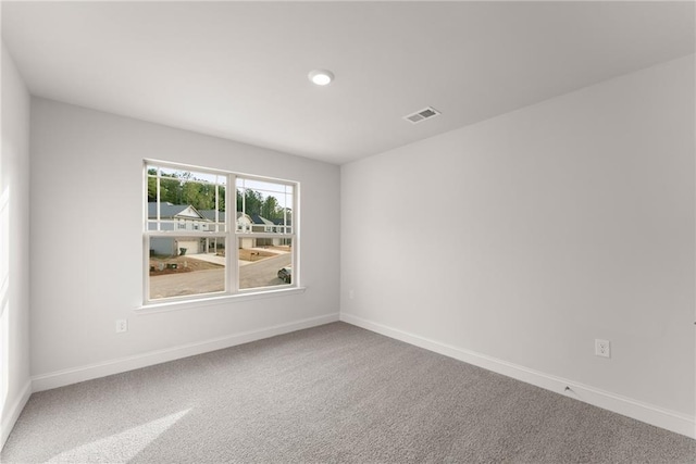 carpeted spare room featuring visible vents, baseboards, and recessed lighting