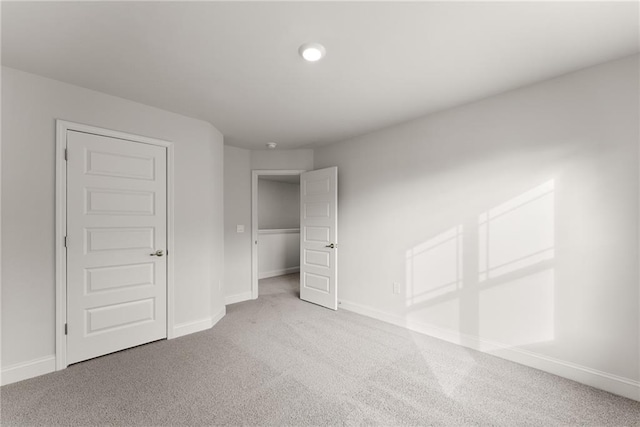 unfurnished bedroom featuring carpet flooring and baseboards