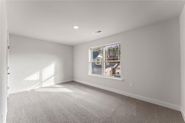 carpeted spare room featuring visible vents, baseboards, and recessed lighting