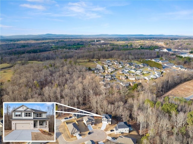 birds eye view of property featuring a view of trees