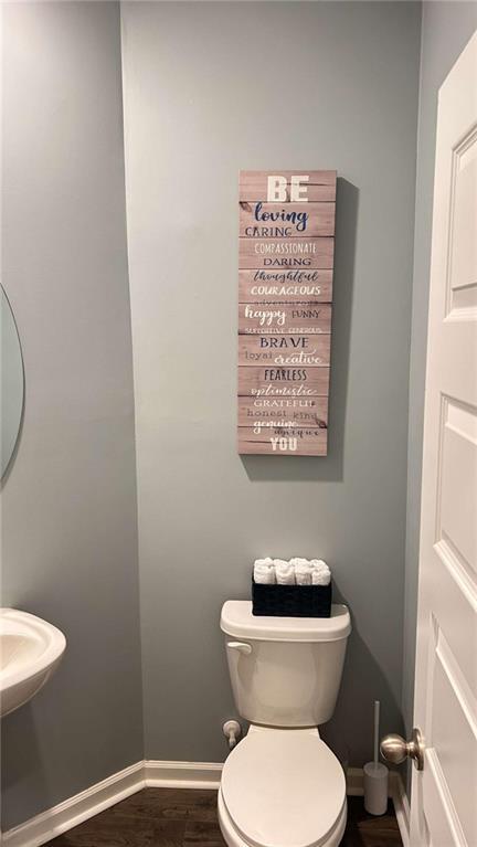 473 Broder Farms Dr, Stockbridge, GA 30281 - bathroom featuring toilet, wood finished floors, baseboards, and a sink