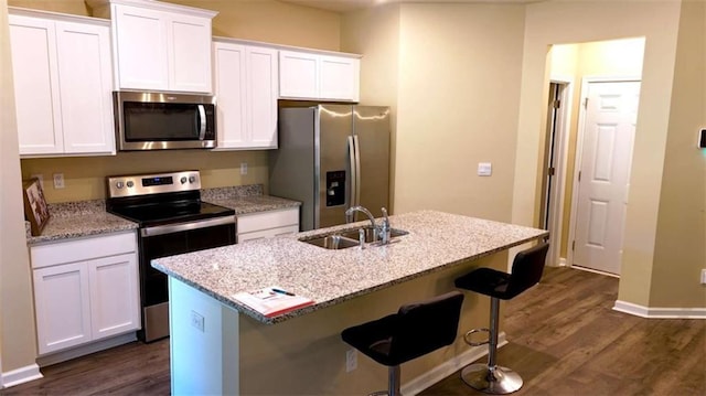 473 Broder Farms Dr, Stockbridge, GA 30281 - kitchen with stainless steel appliances, a sink, dark wood-style flooring, and white cabinetry