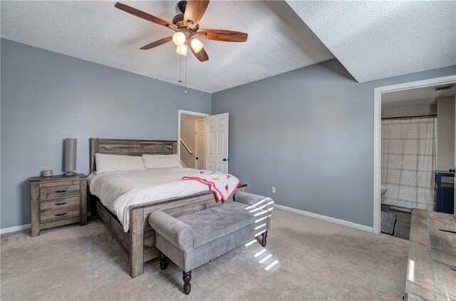 bedroom featuring ceiling fan, light carpet, and a textured ceiling