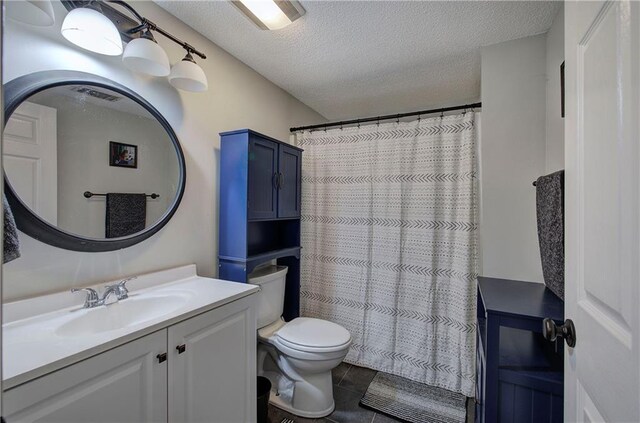 bathroom with a shower with curtain, vanity, toilet, and a textured ceiling