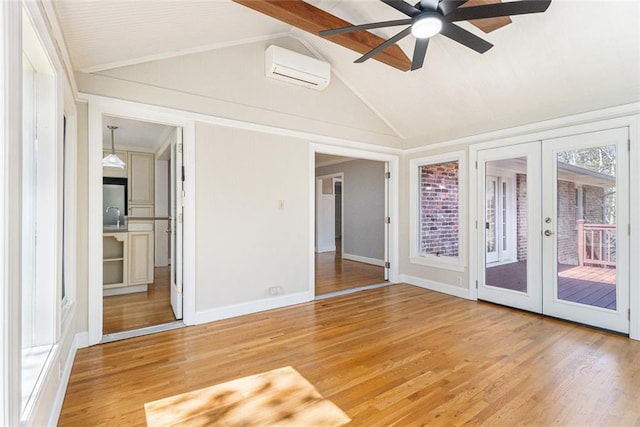 interior space with vaulted ceiling with beams, wood finished floors, and french doors