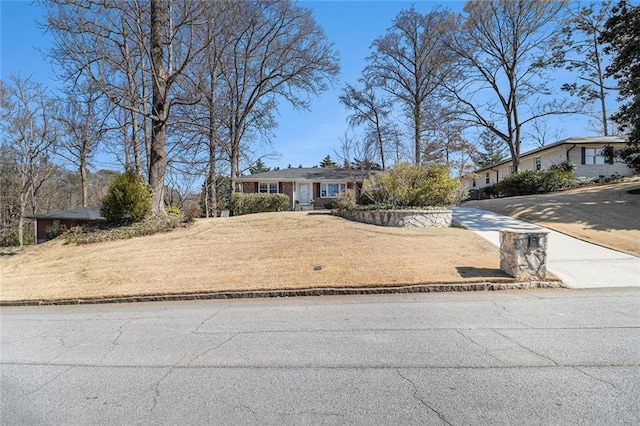 view of front of property with a front lawn and concrete driveway