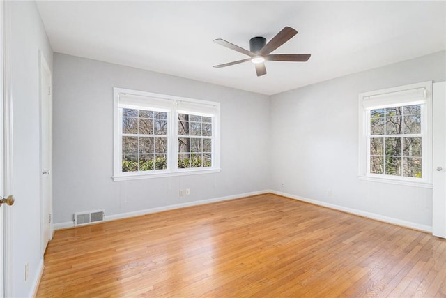 unfurnished room featuring a ceiling fan, light wood-type flooring, visible vents, and baseboards