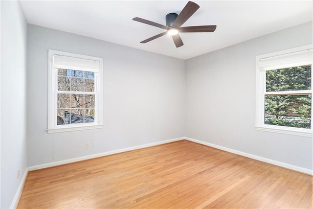 empty room featuring light wood-style flooring, baseboards, and ceiling fan