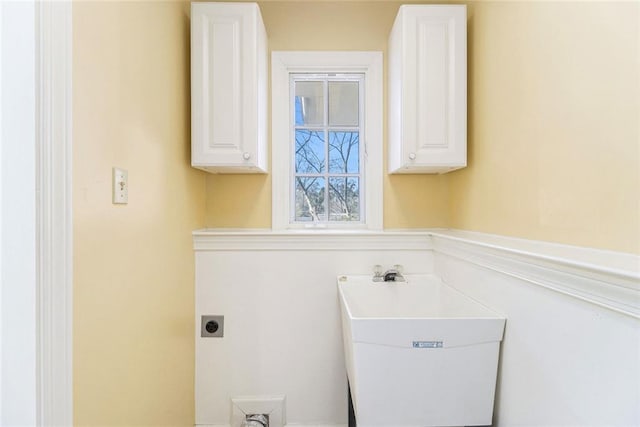 clothes washing area featuring laundry area, a sink, and electric dryer hookup