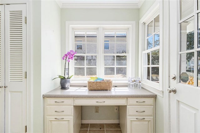 interior space featuring ornamental molding, tile patterned flooring, a wealth of natural light, and built in study area