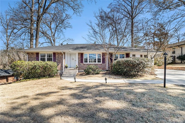 single story home with brick siding and a front lawn