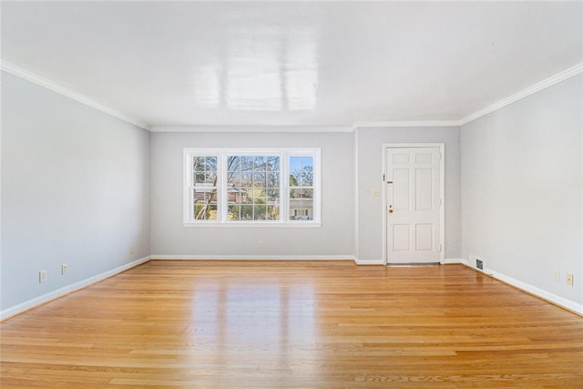 interior space featuring light wood-style floors, ornamental molding, and baseboards