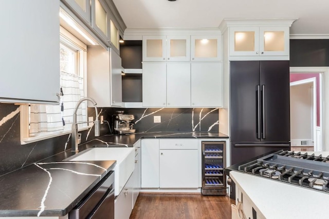 kitchen featuring backsplash, dark wood-type flooring, white cabinets, stainless steel appliances, and beverage cooler