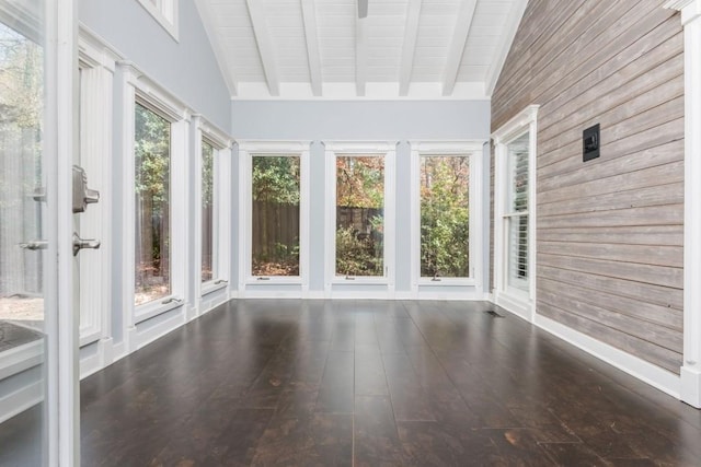 unfurnished sunroom with vaulted ceiling with beams and a wealth of natural light