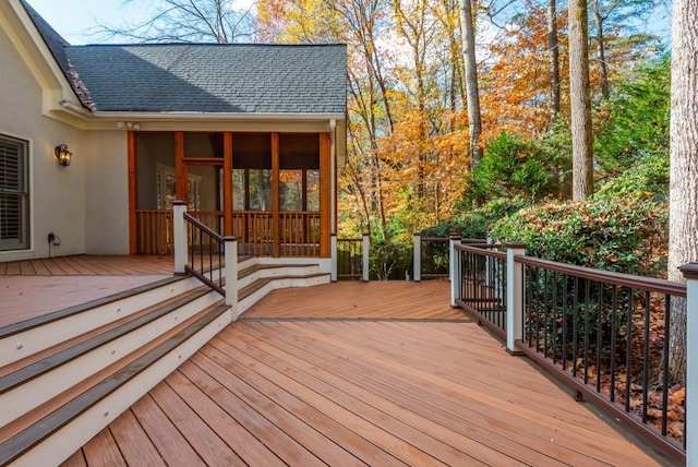 wooden deck with a sunroom