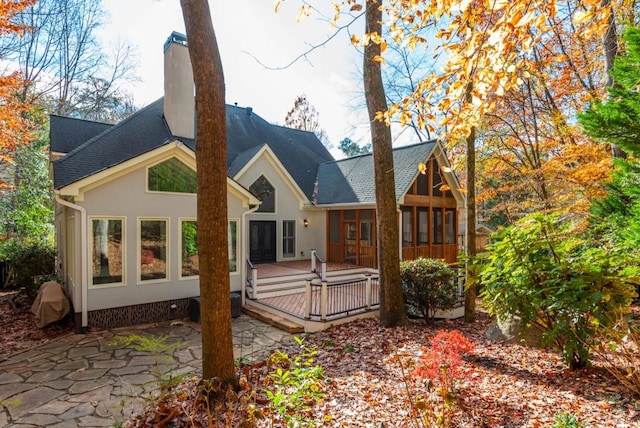 back of house featuring a wooden deck