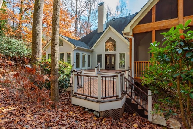 rear view of property with a wooden deck, a sunroom, and french doors