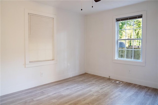 spare room featuring ceiling fan and light hardwood / wood-style flooring