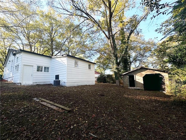 view of side of property featuring an outbuilding and central AC