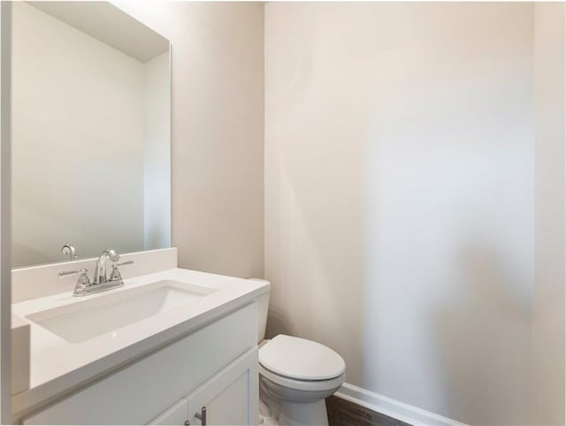 632 Eagles Nest Cir, Auburn, GA 30011 - half bathroom with toilet, wood finished floors, vanity, and baseboards