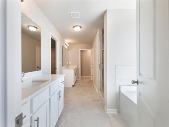 632 Eagles Nest Cir, Auburn, GA 30011 - bathroom with two vanities, a shower stall, a sink, visible vents, and a garden tub
