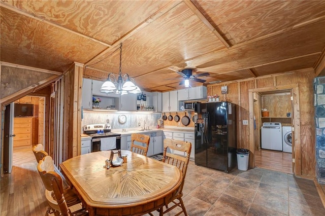 dining room with tile flooring, ceiling fan with notable chandelier, wooden walls, independent washer and dryer, and wood ceiling