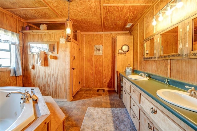 bathroom with wood ceiling, wood walls, large vanity, and double sink