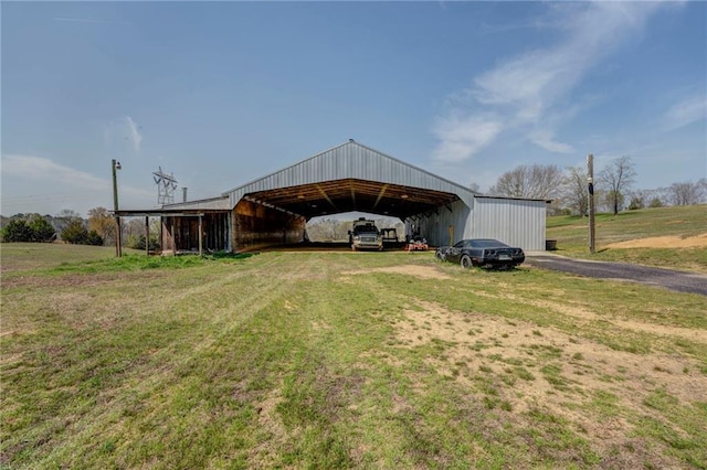 view of shed / structure featuring a carport and a yard