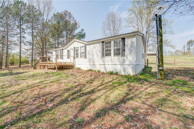 exterior space with a yard and a wooden deck