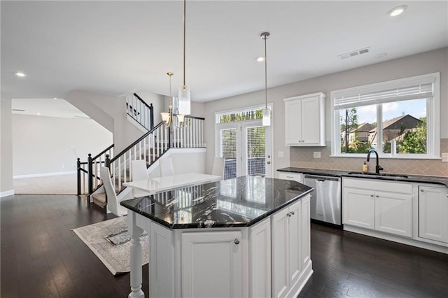 5153 Elkins Ln, Acworth, GA 30101 - kitchen with stainless steel dishwasher, tasteful backsplash, white cabinets, dark wood finished floors, and recessed lighting