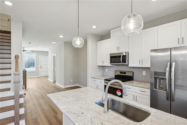 1095 Tucker Ave Unit 401, Atlanta, GA 30310 - kitchen featuring stainless steel appliances, a sink, light wood finished floors, baseboards, and recessed lighting