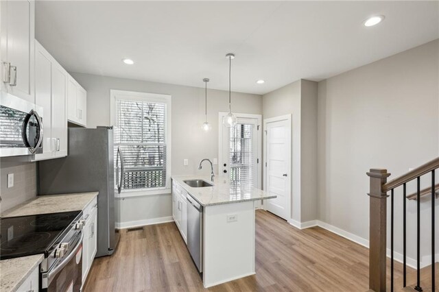 1095 Tucker Ave Unit 401, Atlanta, GA 30310 - kitchen featuring appliances with stainless steel finishes, a sink, baseboards, light wood-style flooring, and decorative backsplash