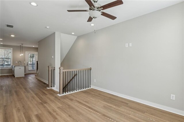 1095 Tucker Ave Unit 401, Atlanta, GA 30310 - empty room featuring wood finished floors, recessed lighting, baseboards, a ceiling fan, and a sink