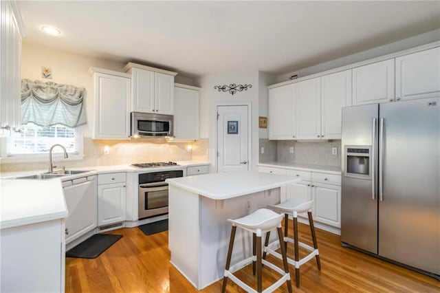 3780 Summit Gate Dr, Suwanee, GA 30024 - kitchen featuring stainless steel appliances, a sink, white cabinets, tasteful backsplash, and recessed lighting