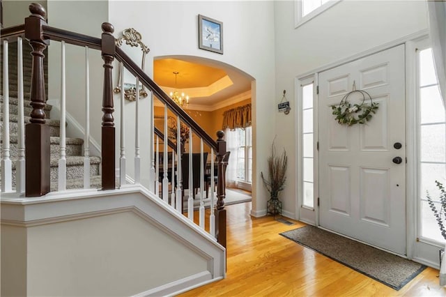 3780 Summit Gate Dr, Suwanee, GA 30024 - entrance foyer featuring arched walkways, wood finished floors, crown molding, stairs, and a towering ceiling