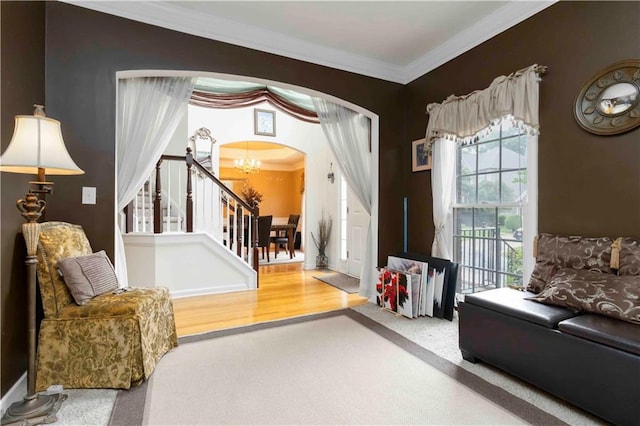 3780 Summit Gate Dr, Suwanee, GA 30024 - carpeted entryway with a chandelier, arched walkways, ornamental molding, and stairs