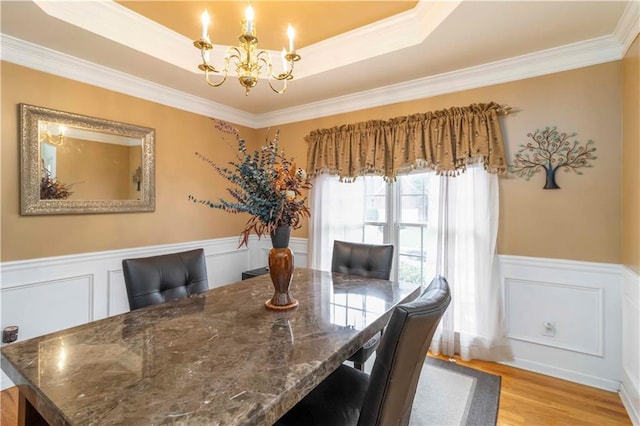 3780 Summit Gate Dr, Suwanee, GA 30024 - dining area with a chandelier, ornamental molding, a decorative wall, a raised ceiling, and light wood-style flooring