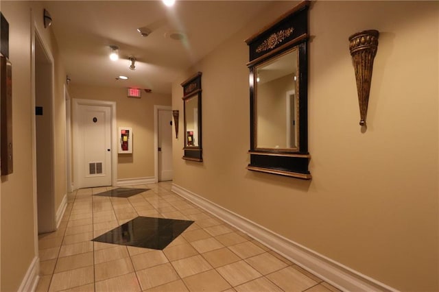 hallway featuring light tile patterned floors