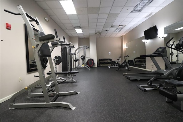 exercise room with a drop ceiling