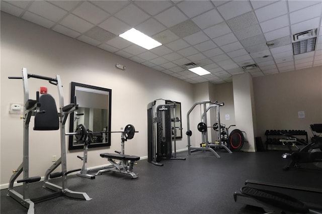 exercise room featuring a drop ceiling