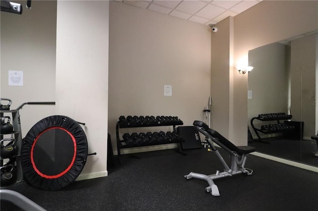 exercise room featuring a paneled ceiling